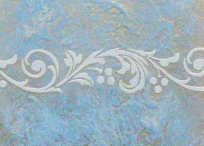 Decorative stencil pattern over patinated blue plaster wall