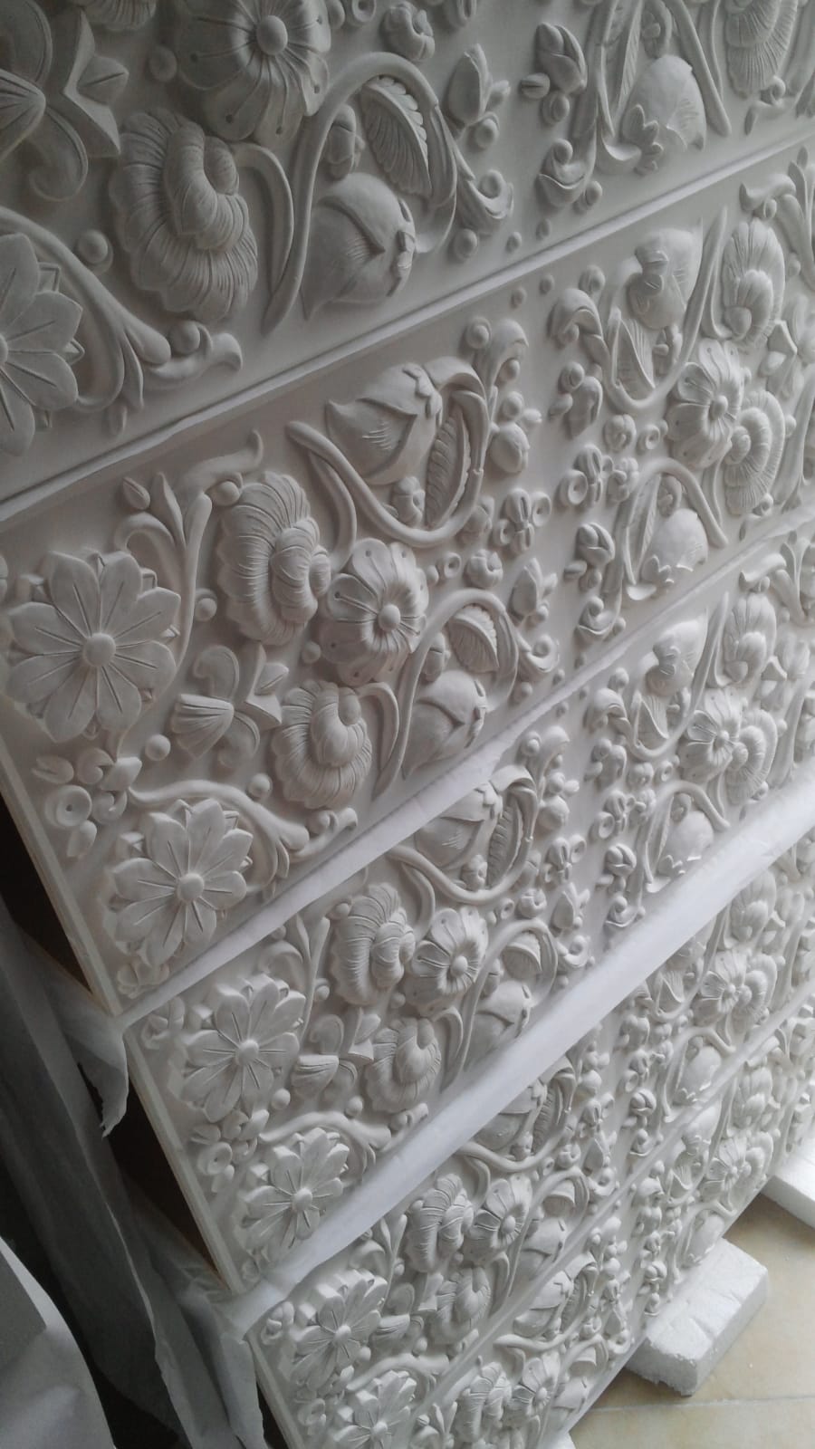 Hand-carved floral relief panel detail