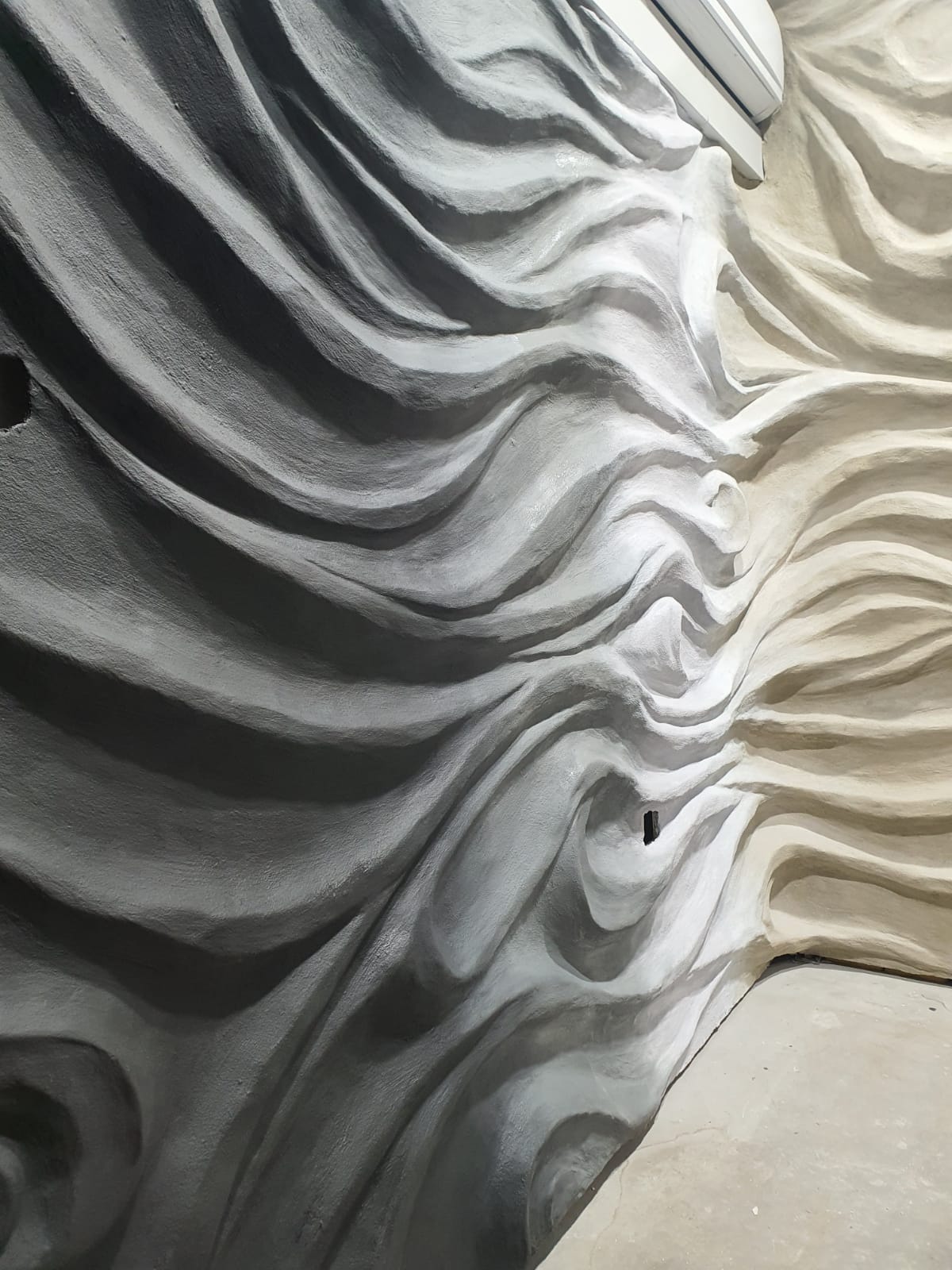 Drapery-flow textured decorative concrete wall